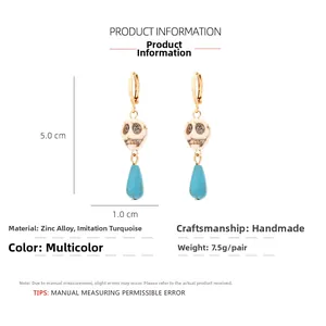 Macro detail of skull drop earrings with turquoise beads and golden zinc alloy hooks
