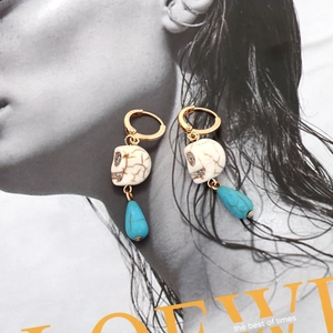 Bohemian skull earrings with gold hoops, blue teardrop stones and vintage gothic style
