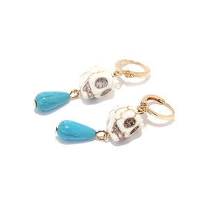 Bohemian skull earrings with turquoise teardrop pendants on gold-tone metal hooks