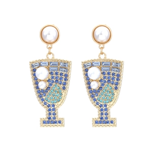 Golden wine glass earrings with blue rhinestones and white pearls on a white background