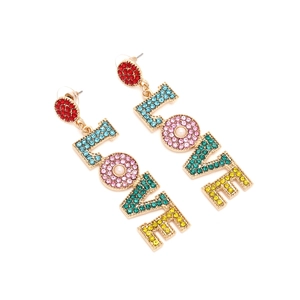 Detailed macro view of gold-tone LOVE earrings featuring multicolor rhinestones and pearls