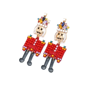 Colorful Nutcracker earrings with crystals and pearls on a white background
