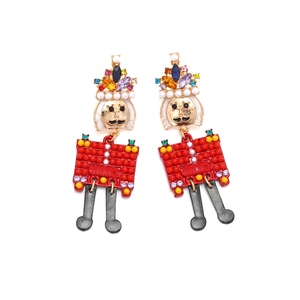 Nutcracker soldier drop earrings with colorful crystals and pearl crown on white base