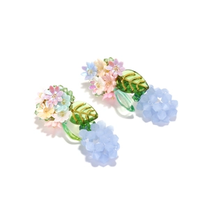 Handmade pastoral style earrings with colorful woven flowers and green leaves on white