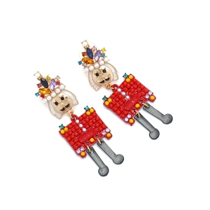 Detail of nutcracker earrings with colorful rhinestones, beads and movable black charms