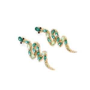 Detail of snake earrings with green crystals and gold plating in an elegant S-curve design