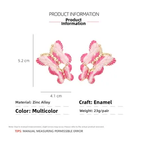 Pink enamel butterfly earrings in zinc alloy, dimensions 5.2cm x 4.1cm with golden edges