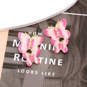 Pink enamel butterfly earrings in gold finish featuring a layered 3D insect wing design