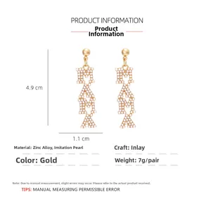 Detail view of MAMA letter earrings in gold alloy with pearls, 4.9cm drop length