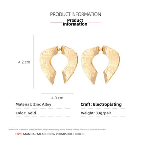 Detail view of gold textured heart earrings showing dimensions and material parameters