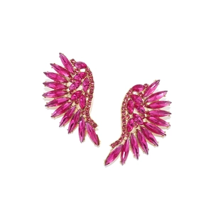 Macro detail of magenta crystal wing earrings with gold-plated base and marquis stones