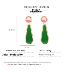 Detail view of pink and green resin drop earrings with zinc alloy frame, 8.4cm length