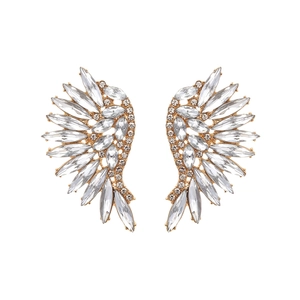 Detail of wing-shaped golden earrings with sparkling marquise and round cut crystals