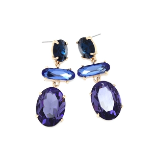 Detail view of elegant multi-layer geometric earrings with blue and purple glass crystals