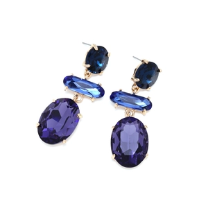 Close-up of geometric layered earrings with blue and purple crystal glass stones
