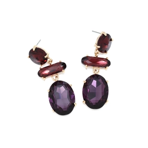 Detail of three-tier geometric crystal drop earrings with purple faceted stones and gold claws