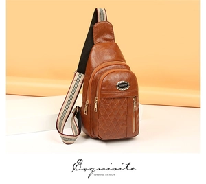 Macro detail of brown quilted crossbody bag showing layered zippers and striped strap