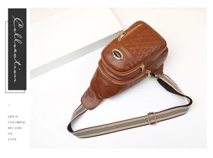 Detailed view of brown quilted crossbody bag with multiple zippers and striped strap