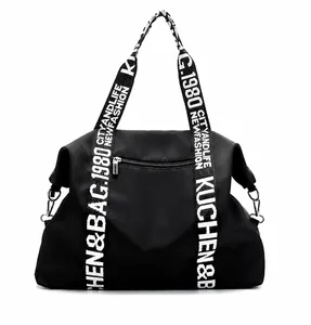 Rear view of waterproof nylon tote bag with functional zipper pocket and patterned strap