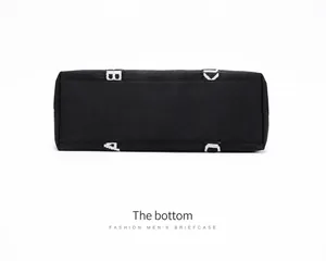Detailed bottom view of black nylon travel tote showing reinforced stitching and logo strap