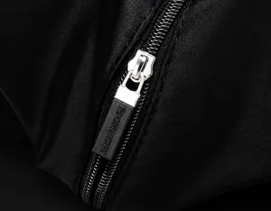 Detail of custom matte black zipper puller on water-resistant nylon shoulder bag