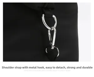 Detail of durable silver metal hook and D-ring on waterproof nylon shoulder bag strap