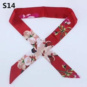 Macro detail of a red floral satin twilly scarf with pink flowers for bag handles