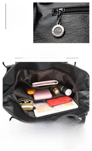 Detail der schwarzen Handtasche mit geräumigen Innenfächern und hinterem Reißverschluss