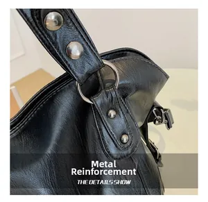 Detail view of reinforced silver hardware and durable lychee texture on black handbag