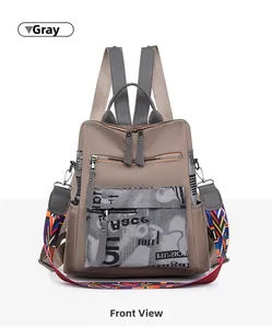 Detailed front view of grey oxford fabric backpack with stylish graffiti pocket design