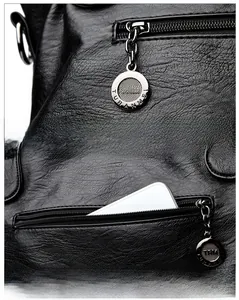 Detail der Premium-Leder-Tote mit Lychee-Struktur, Metallreißverschluss und Anti-Diebstahl-Tasche