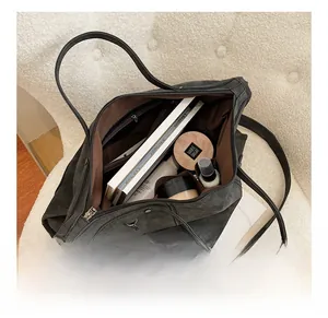 Internal view of dark grey suede tote bag showing spacious capacity and zip pocket