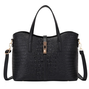 Black crocodile embossed tote bag with gold metal clasp and adjustable shoulder strap