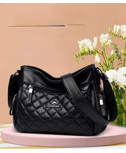 Close-up of quilted black leather shoulder bag with metallic kangaroo logo and texture