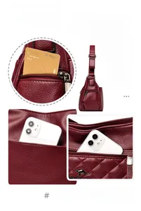 Detail view of burgundy crossbody bag featuring side pockets and quilted leather texture