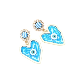 Detailed view of bohemian heart earrings with evil eye design and blue marble finish