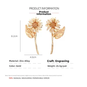 Detail view of large gold sunflower earrings with 8.2cm height and intricate textures