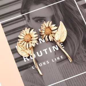 Golden sunflower earrings with detailed metallic petals and textured floral centers