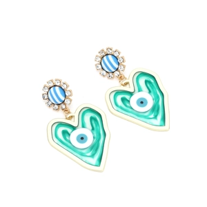 Macro view of gold heart earrings featuring green marble texture and devil's eye detail