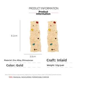 Detail view of gold vintage geometric earrings with colorful rhinestones and dimensions
