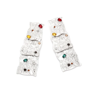 Macro detail of silver vintage tiered square earrings with colorful rhinestones and texture