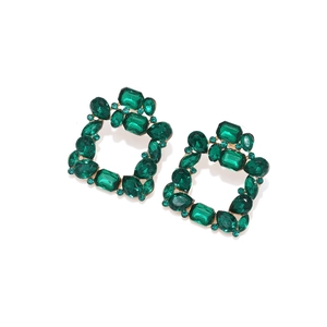 Detail of luxury geometric gold earrings with faceted green crystals and square emerald design