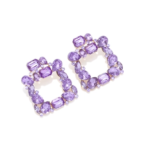 Detailed view of luxury geometric square earrings with purple crystals on gold alloy