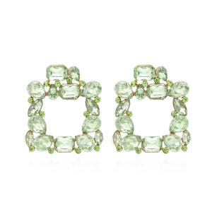 Macro view of square light green crystal drop earrings with gold alloy setting