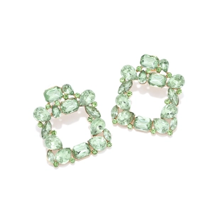 Macro view of luxury square mint green crystal earrings with gold geometric setting