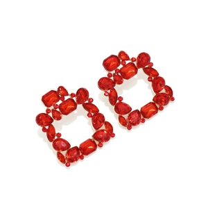 Detail of luxury red square crystal earrings with golden alloy settings and faceted stones