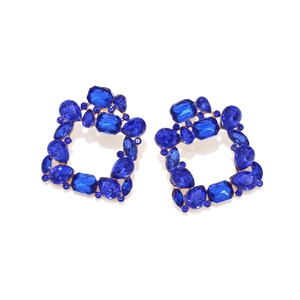 Close-up of geometric hollow earrings with sparkling blue crystal and gold alloy finish