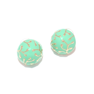 Detail of round mint green enamel earrings with golden coral patterns and branch texture