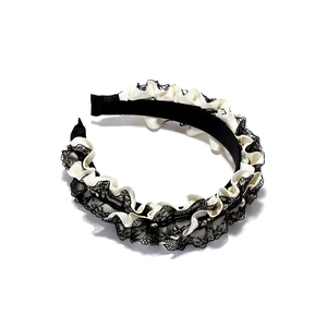Detail of pleated white satin and black lace headband with crystal embellishments
