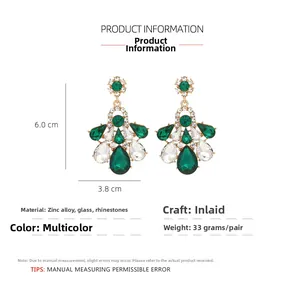 Close-up of vintage emerald glass chandelier earrings with zinc alloy rhinestone inlay